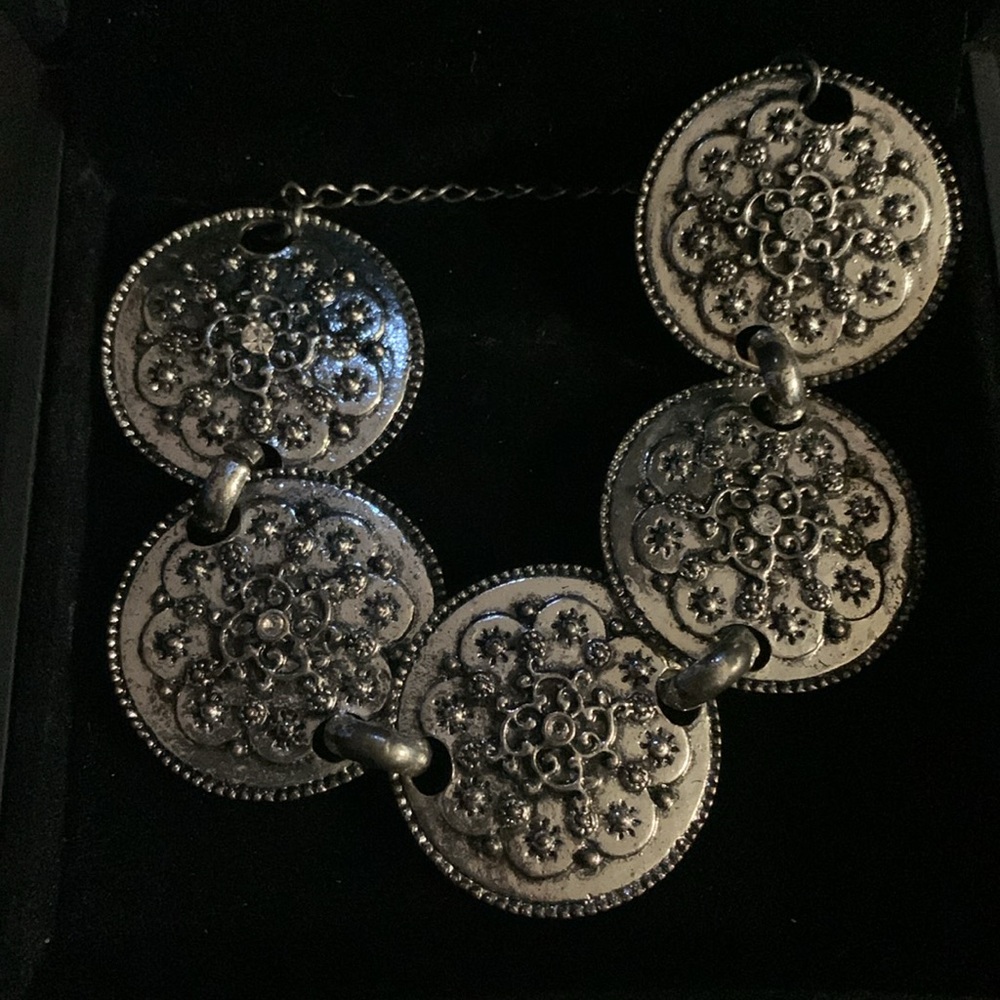 Chunky silver toned chain bracelet with large discs designed